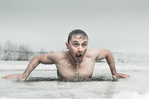 Man taking plunge in ice bath