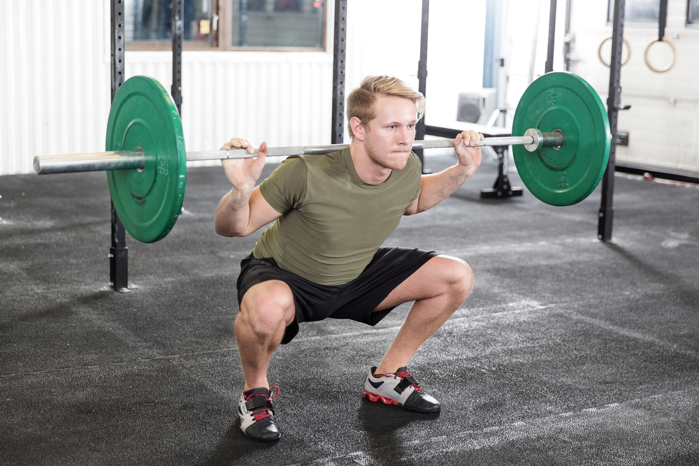 Man doing front weighted squat