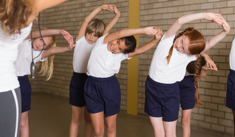 School children stretching their arms