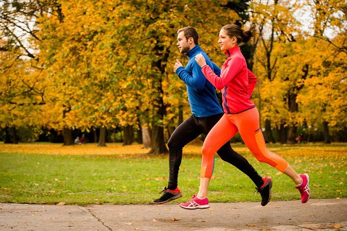 two people jogging in a park