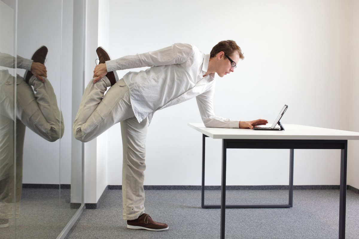 man stretching at desk