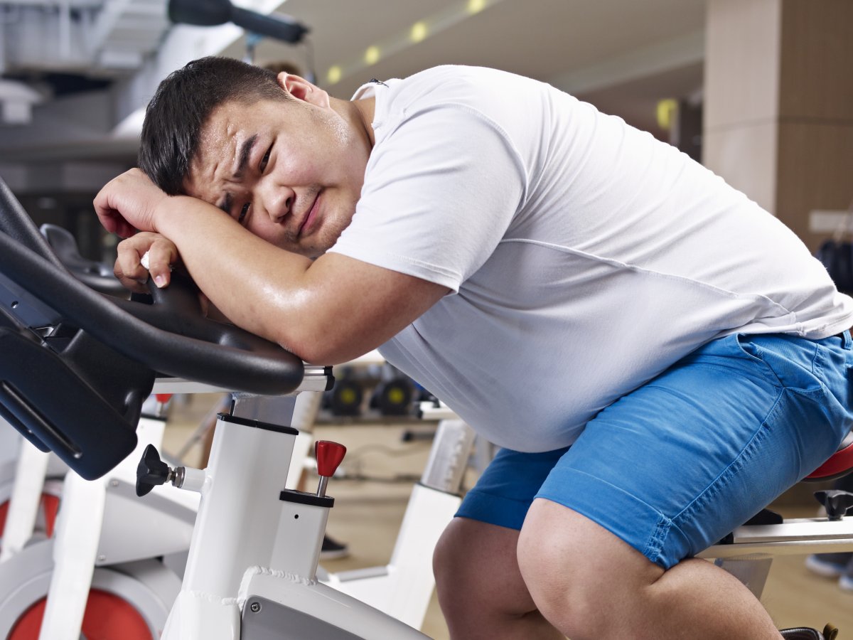 Fat man on exercise bike