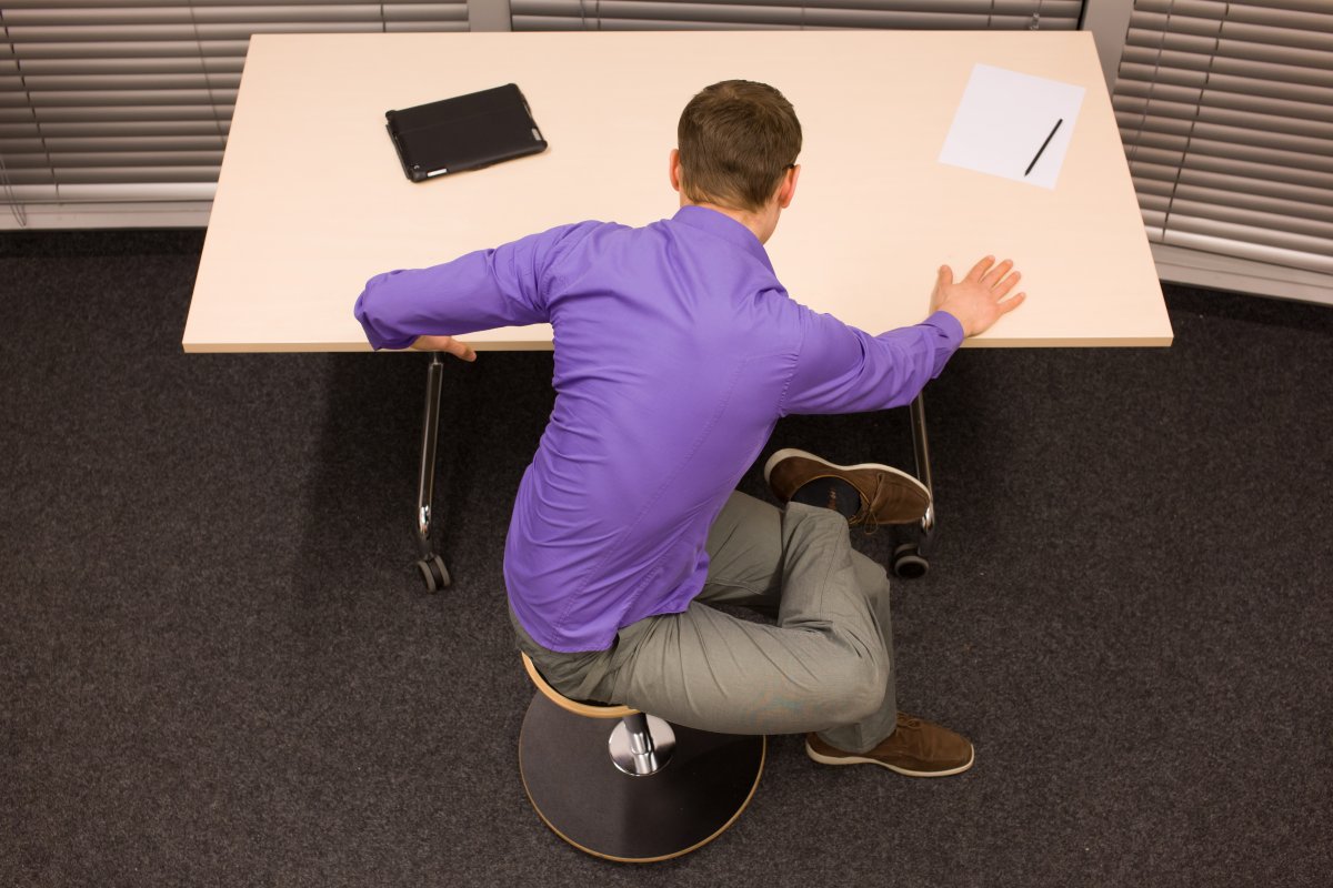 Man exercising at desk