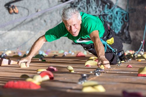 Mature man rocking climbing 