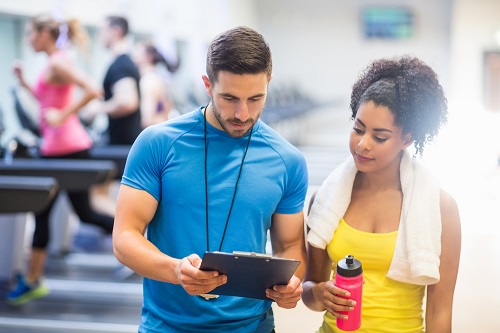 PT showing client results in gym