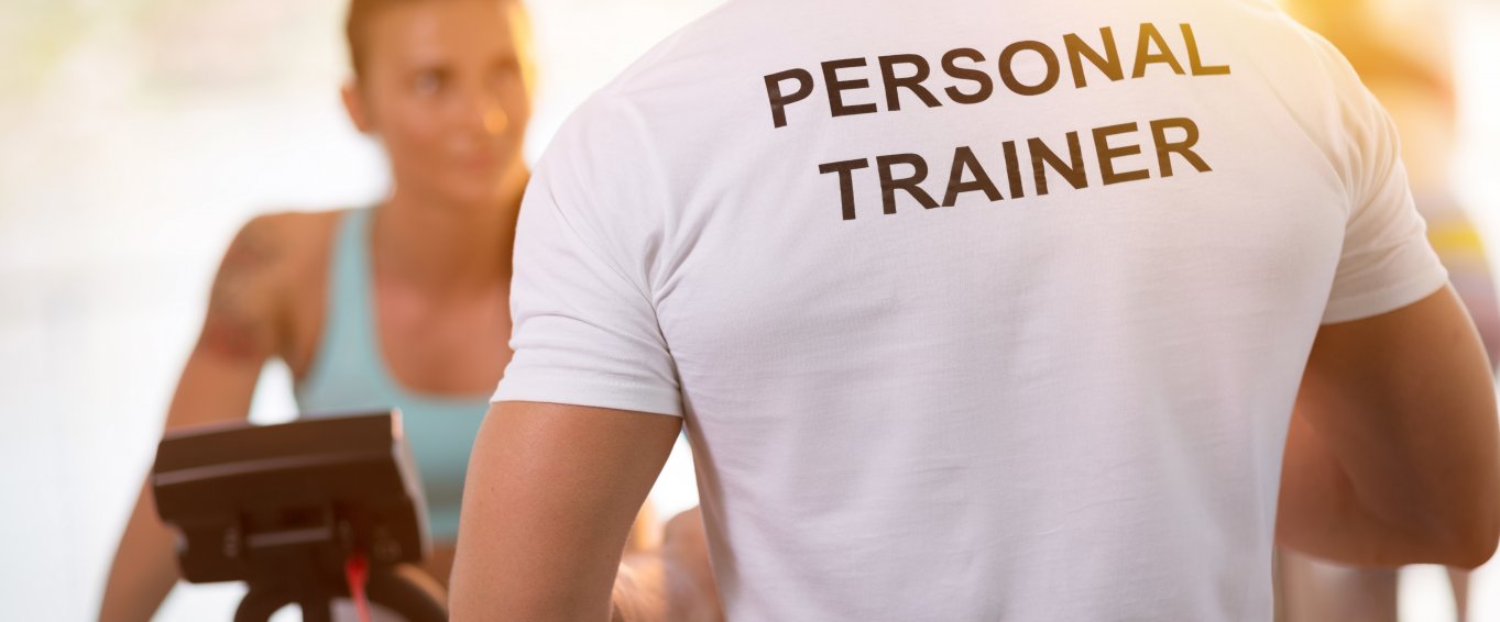 Personal Trainer training client on an exercise bike