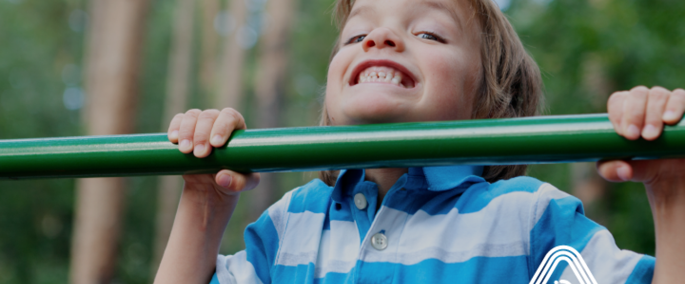 Child doing pull up on bar