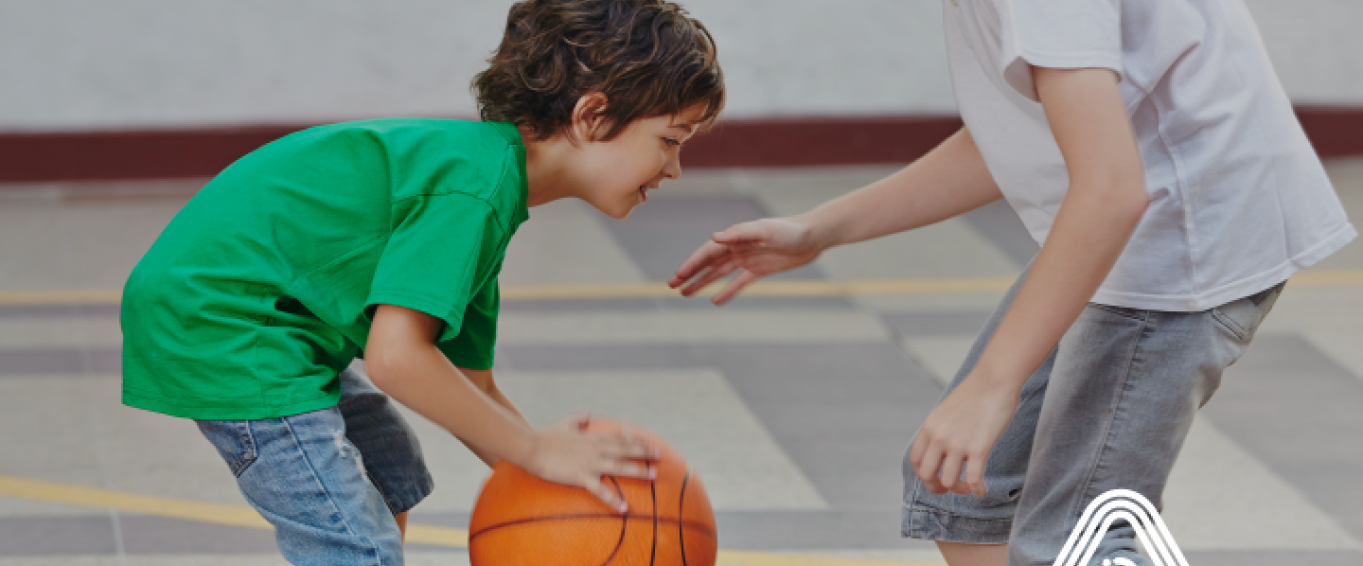 Young children playing basket ball