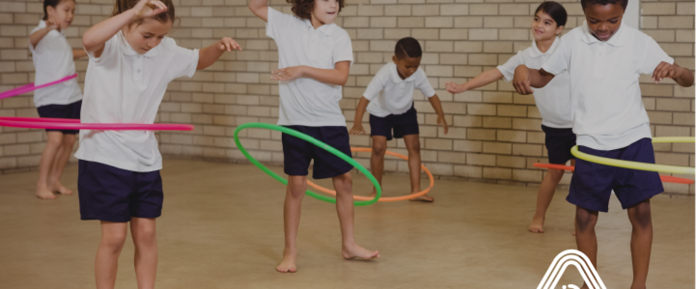 Kids playing with hula hoops in school