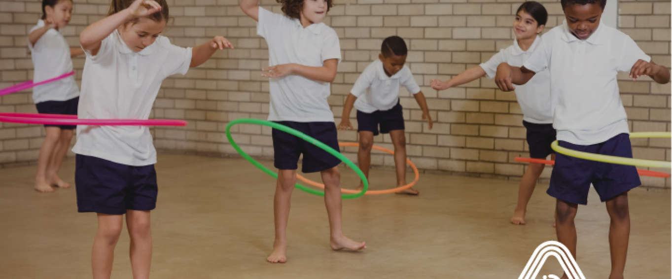 Kids playing with hula hoops in school Kids playing with hula hoops in school