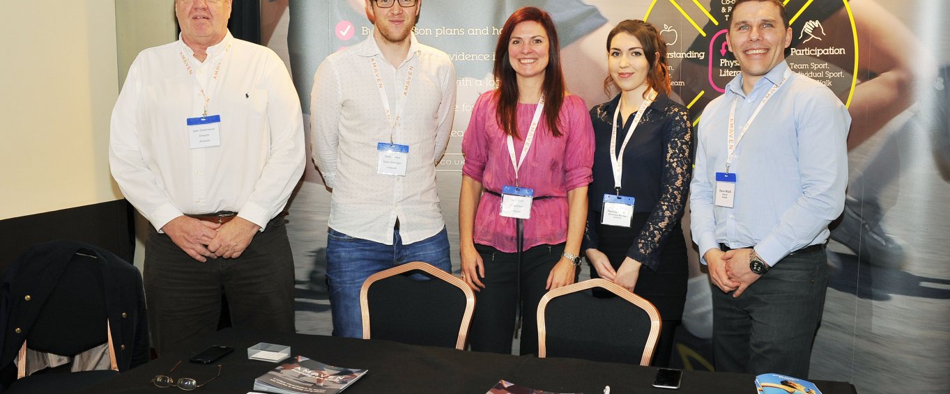 members of Amaven standing at conference 