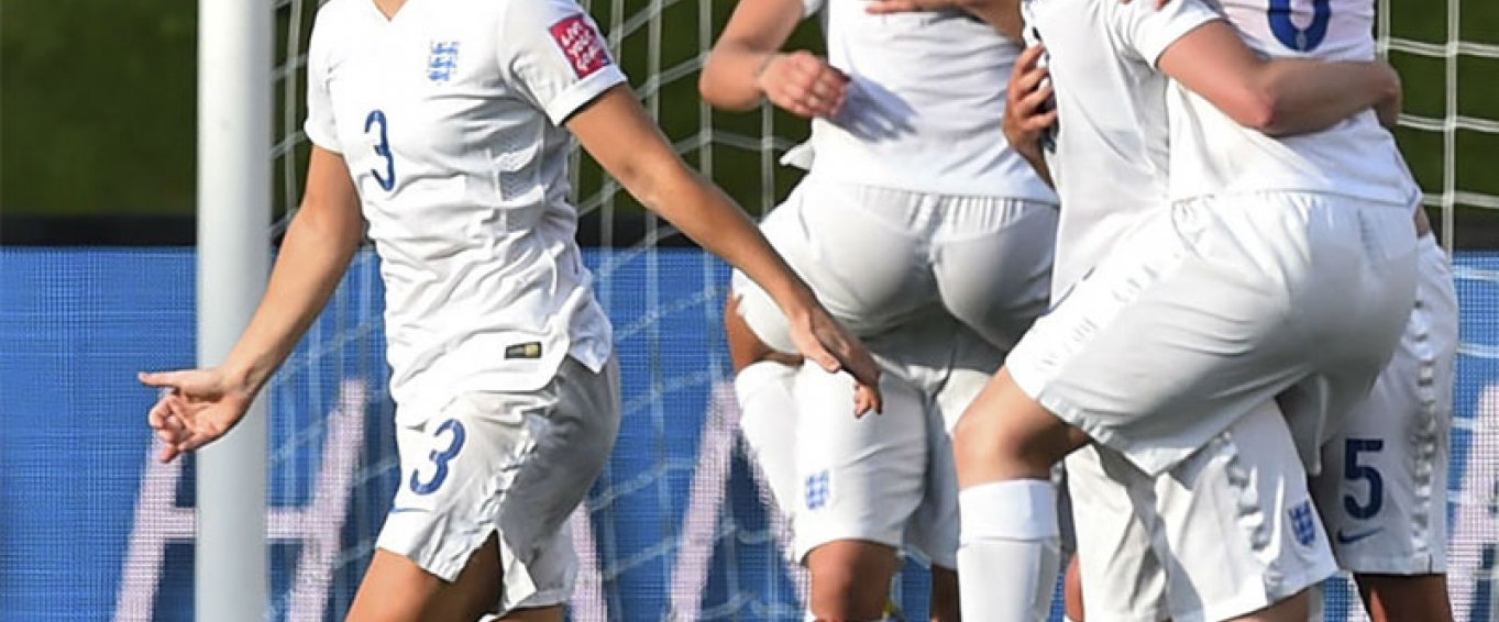 Women's football team celebrating a goal