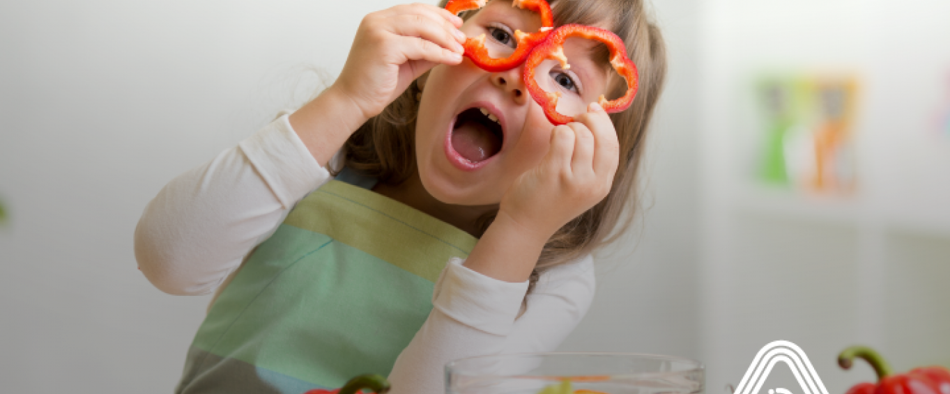 Child playing with vegetables cooking