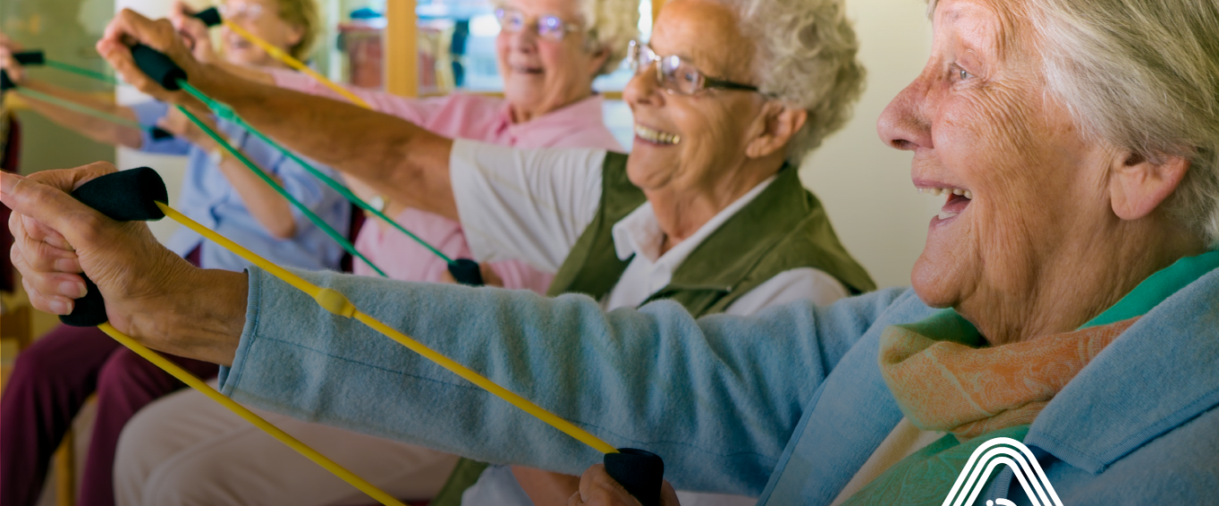 Group of older people sat down doing exercises Group of older people sat down doing exercises