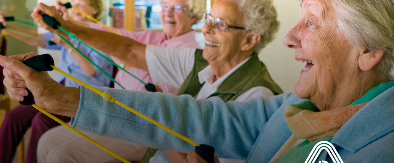 Group of older people sat down doing exercises