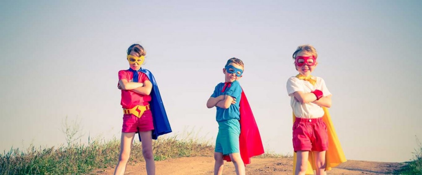 Three Children Posing in Superhero Capes and Masks Three Children Posing in Superhero Capes and Masks