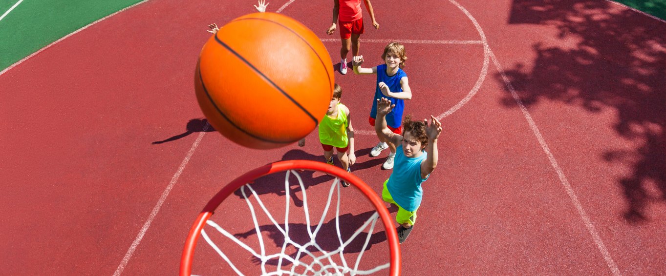 Young Children Shooting Basketball Hoops
