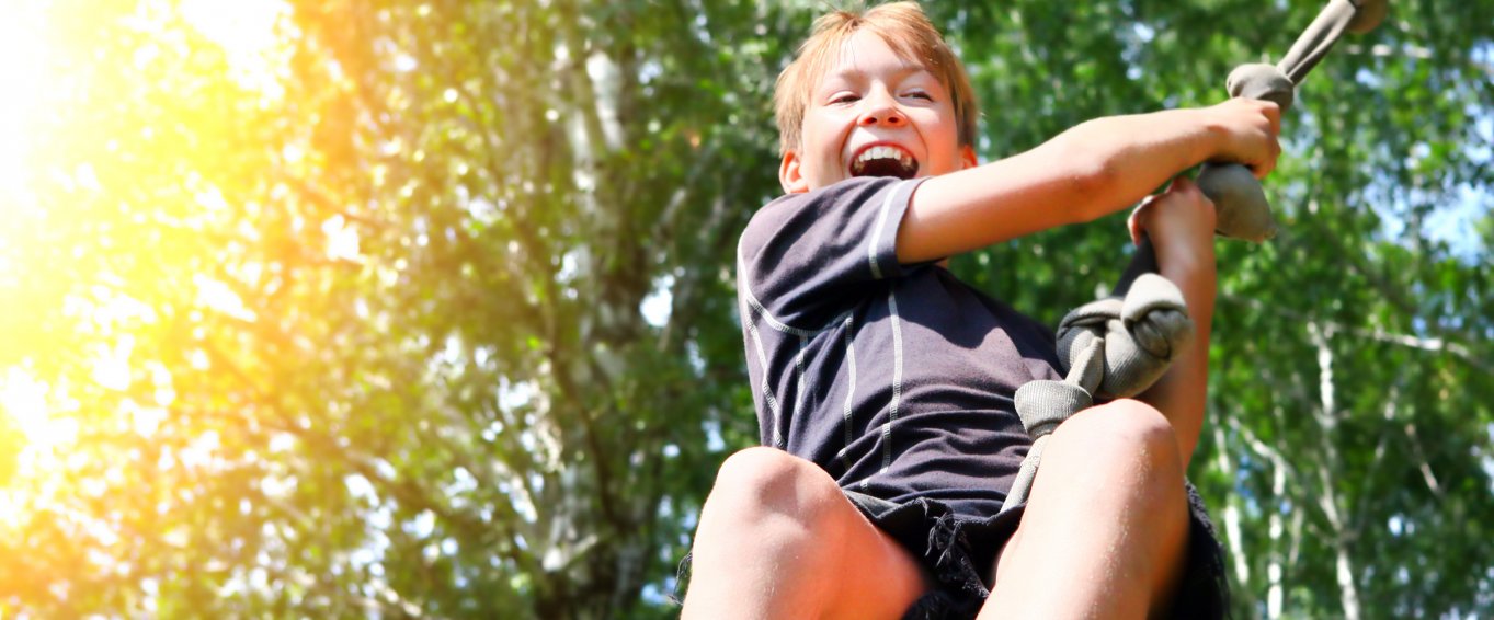 Grinning Child on a Rope Swing