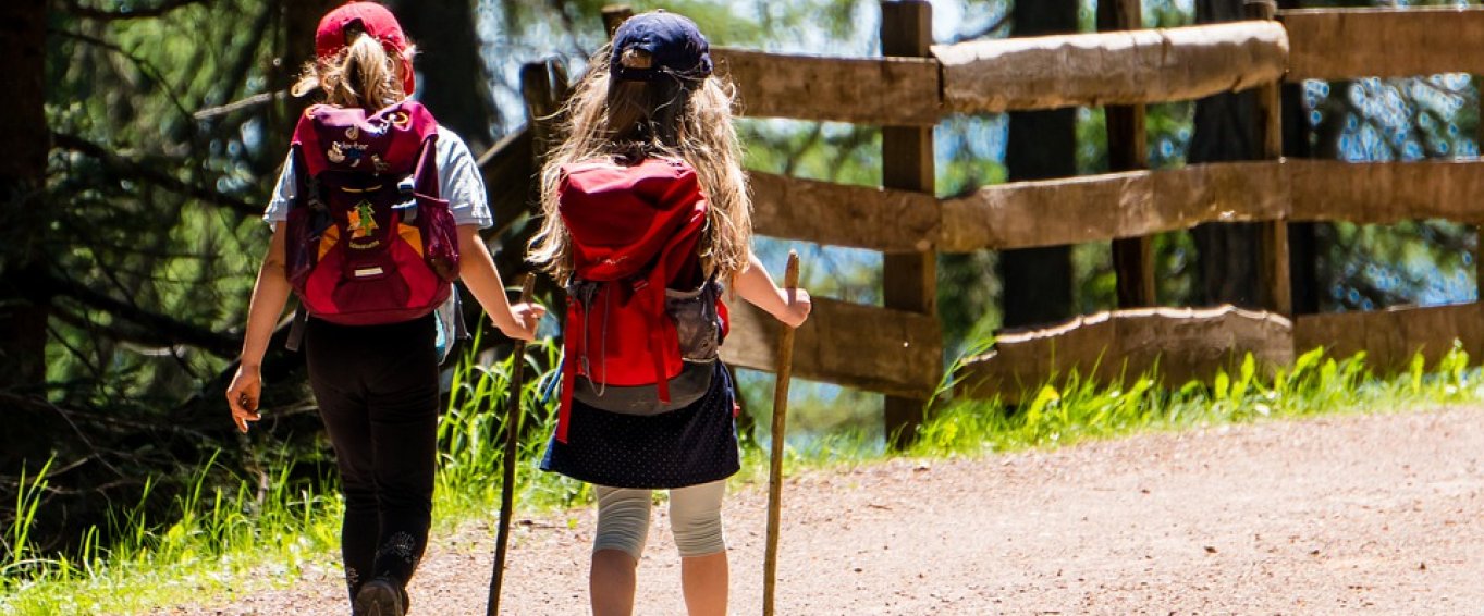 Two Young Girls with Backpacks Going on a Hike