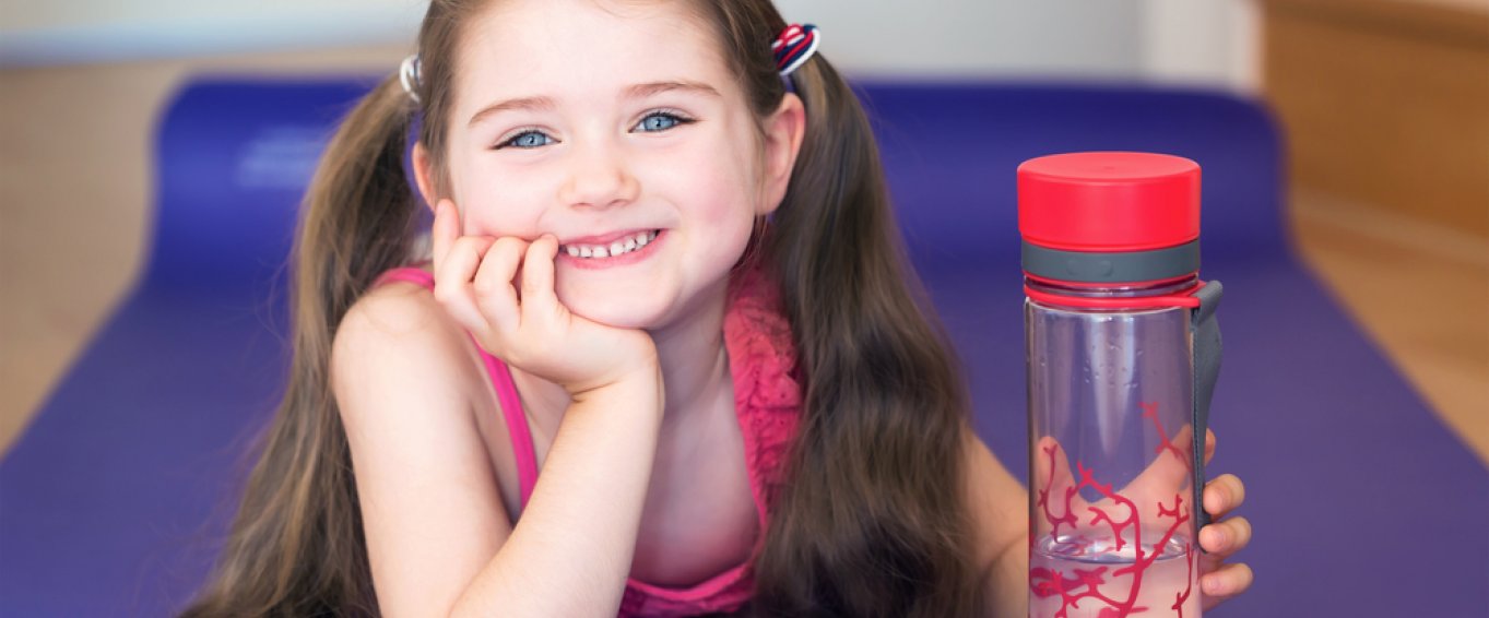 Smiling child holding a water bottle
