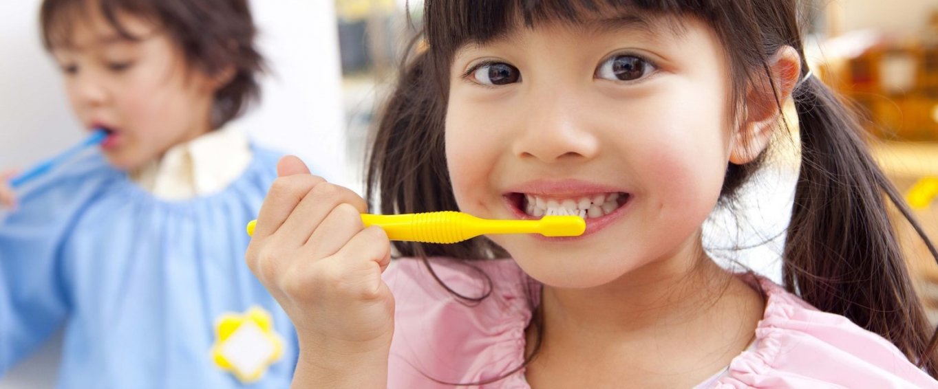 Young Girl Demonstrating Proper Toothbrushing Technique