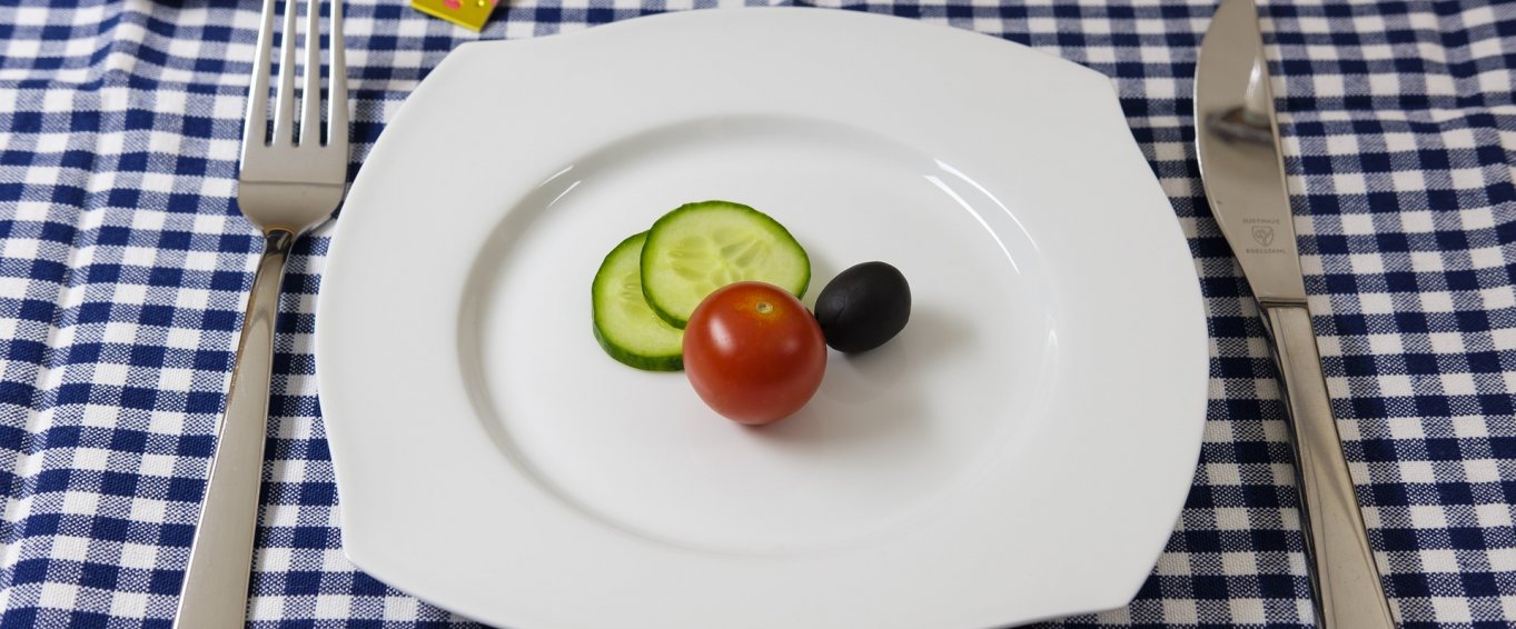 Dinner Plate with Slices of Cucumber and a Tomato 