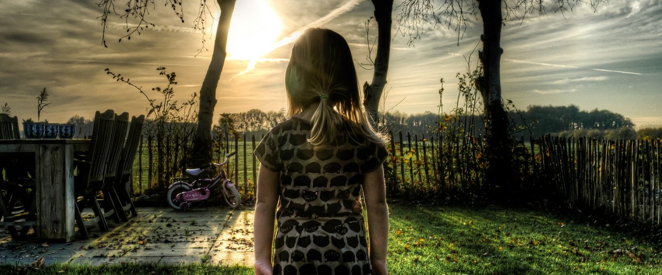 Young Girl with a Bike in the Garden