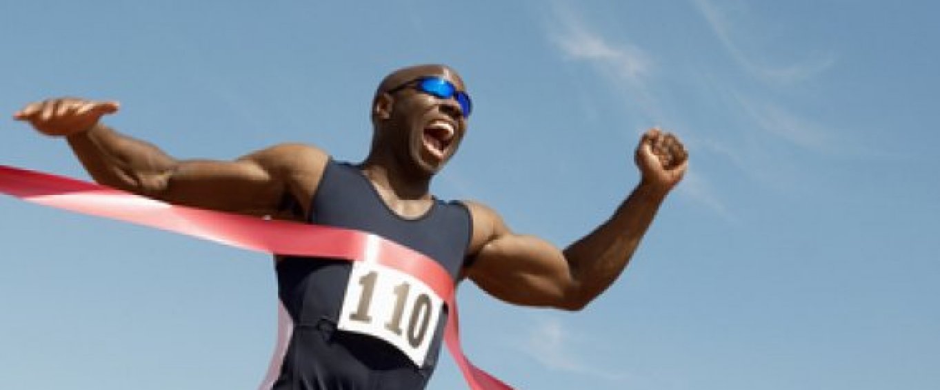 Athlete running through the finish line