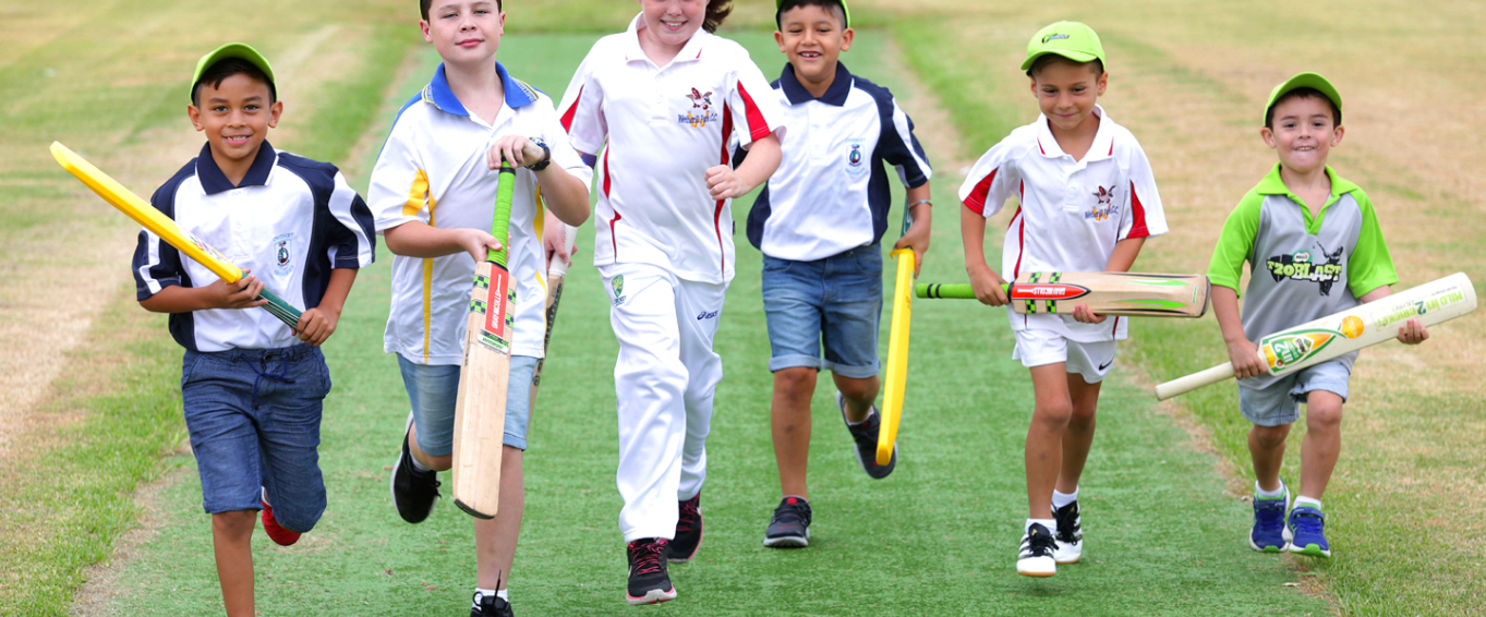 Six young boys running while holding cricket bats Six young boys running while holding cricket bats
