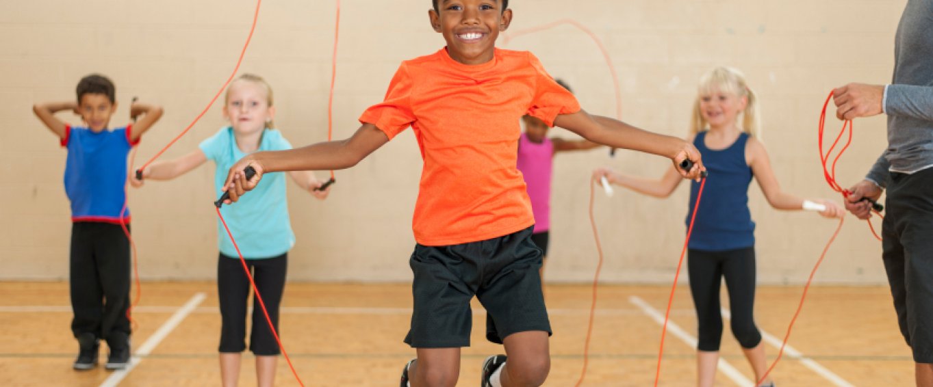 Children Playing Jump Rope in Gym Class Children Playing Jump Rope in Gym Class