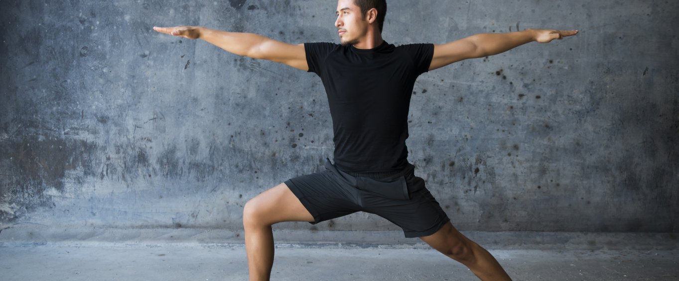 Man in Wide Legged Yoga Pose with Hands Outstretched