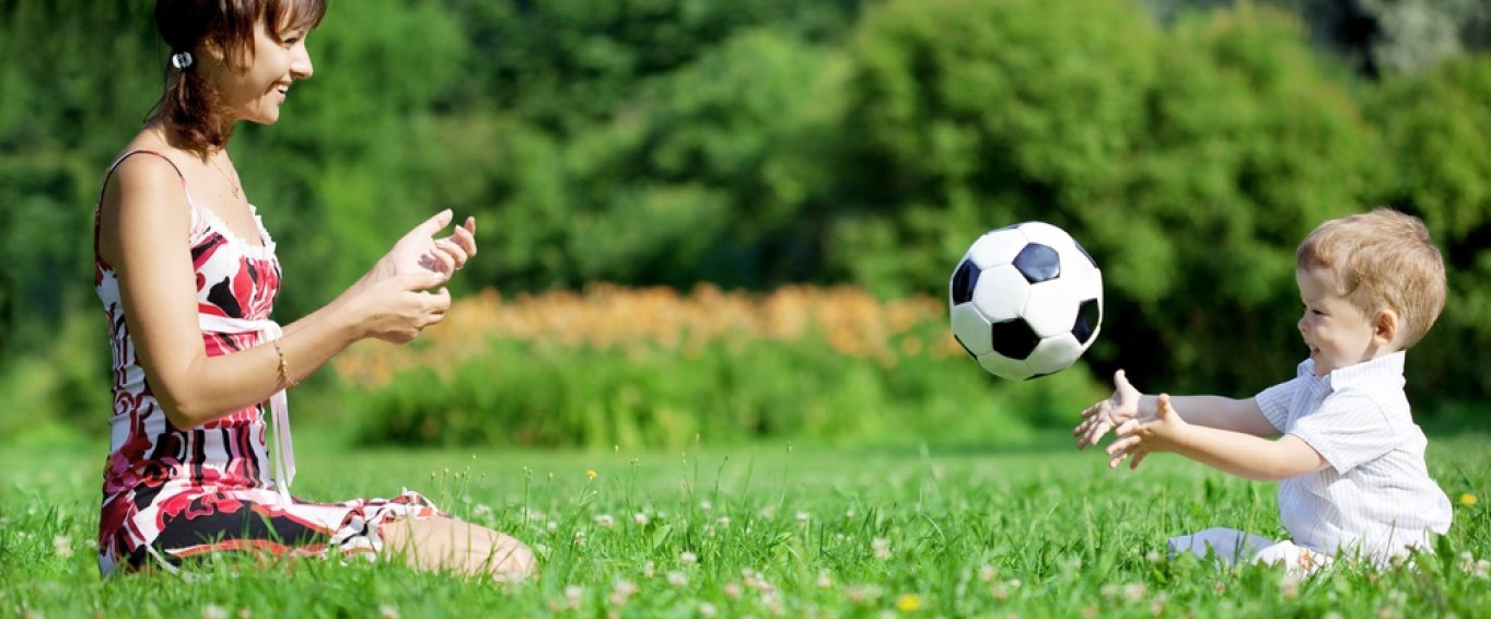 Mother and Child Playing Catch in a Field 