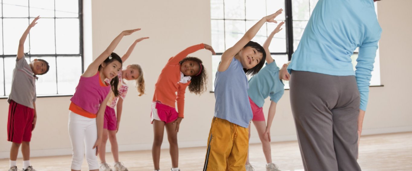 Children Doing Stretches With Their Teacher Children Doing Stretches With Their Teacher