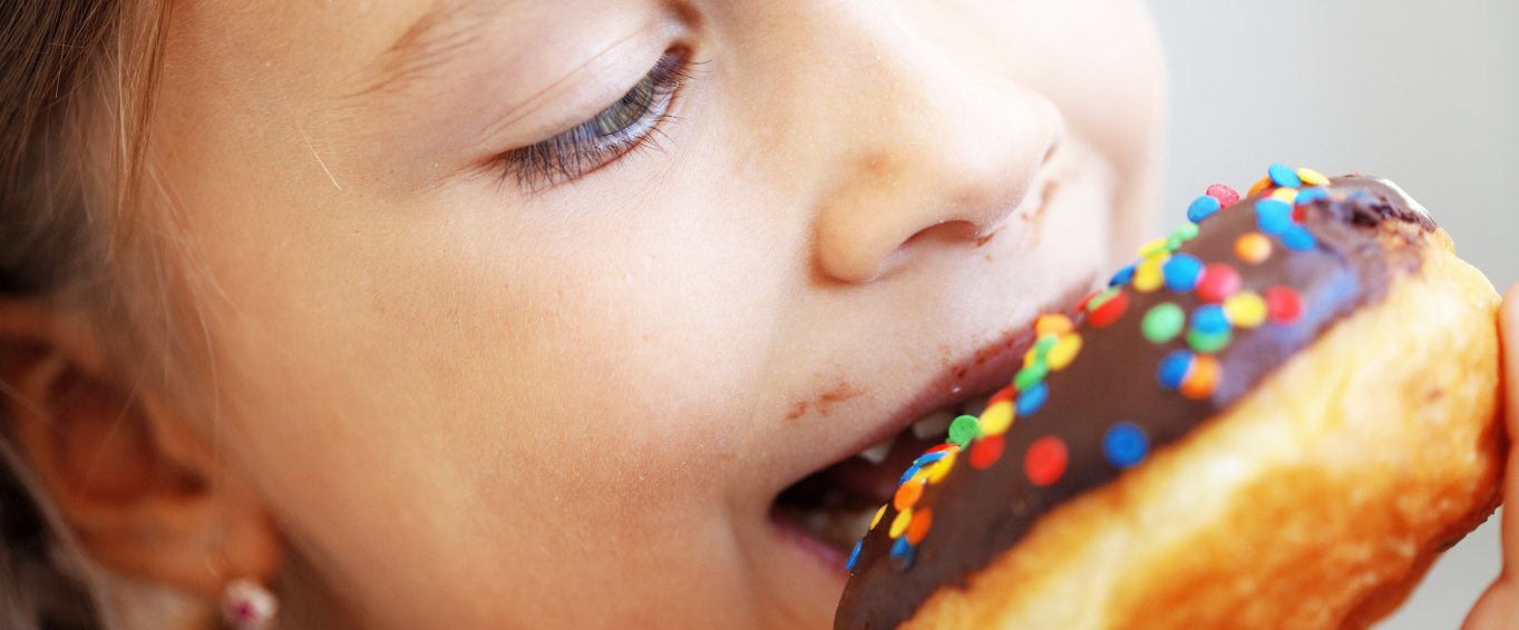 Will Theresa May take action against obesity? Child eating doughnut