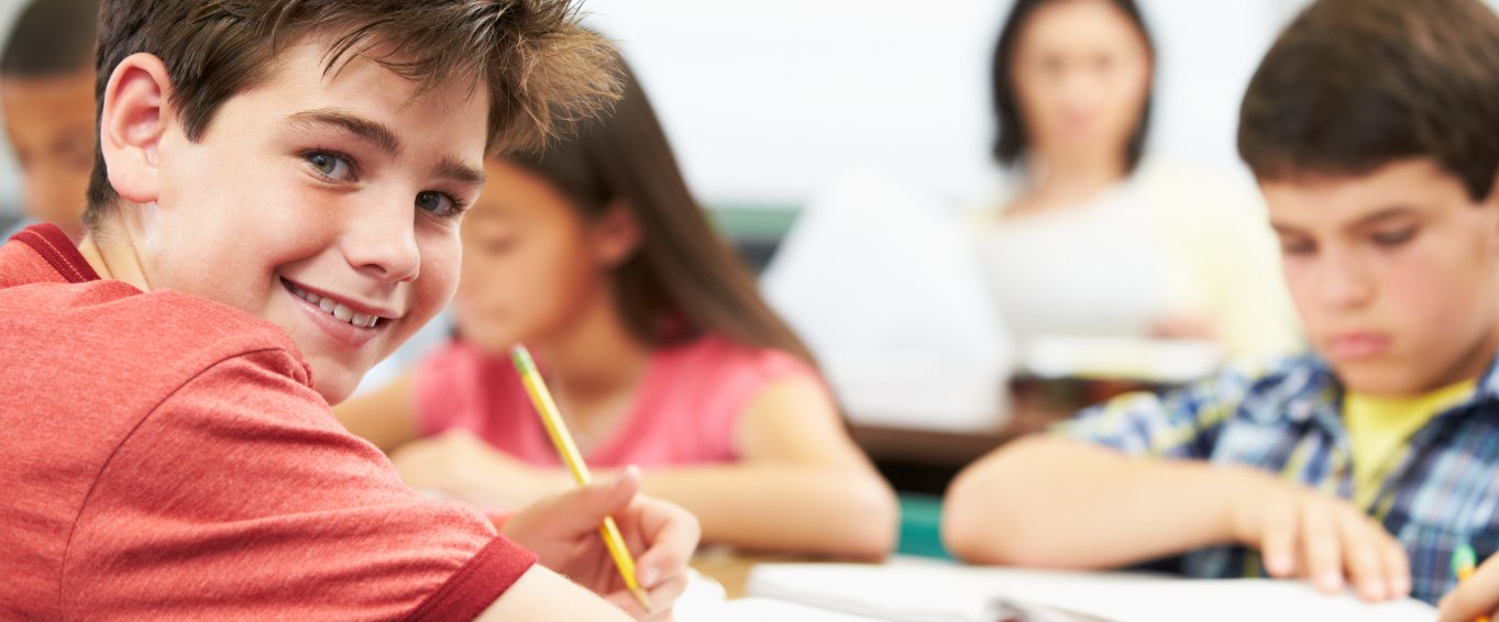 Young boy learning at school