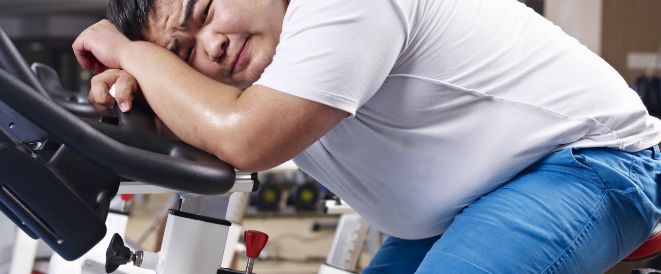 Overweight man on an exercise bike