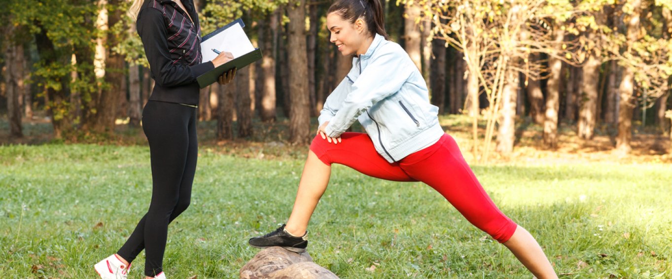 Woman stretching in the woods