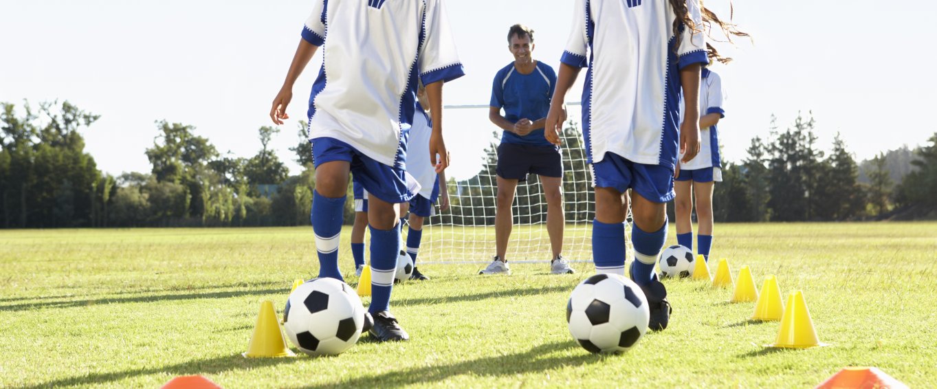 Girls and boys playing football soccer