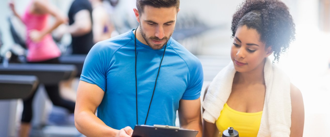 Personal Trainer showing client her results