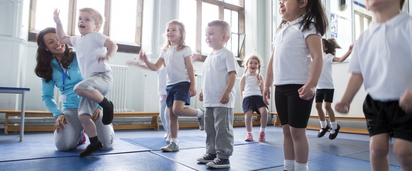 Primary School Pupils Exercising on Gym Mats