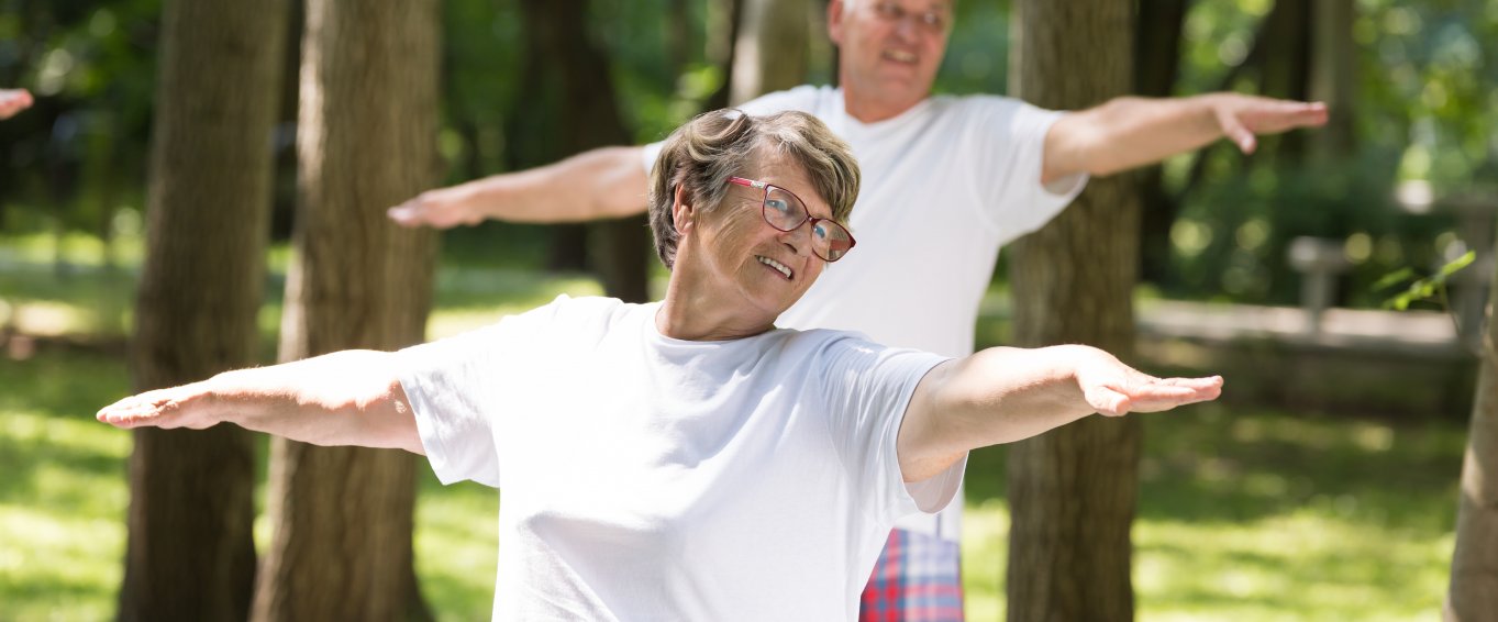 Older adults doing yoga outside
