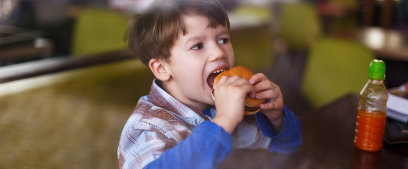 Young Boy Eating a Burger 