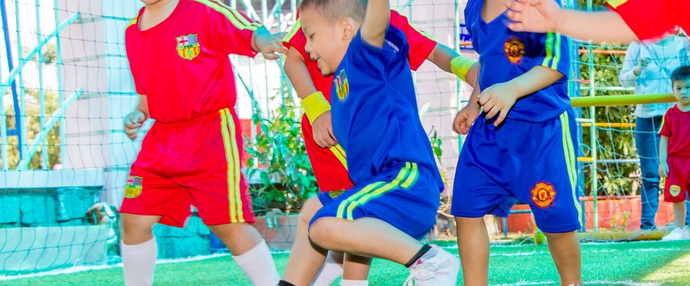 4 children playing football