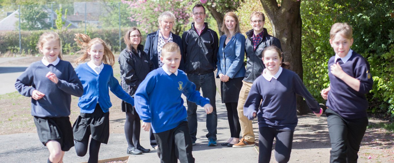 School Kids in School Uniform Running in Front of Their Teachers