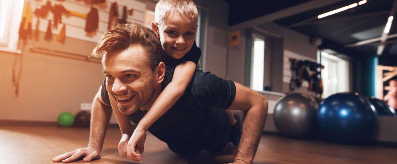 Dad and Young Son Doing Push Ups Together