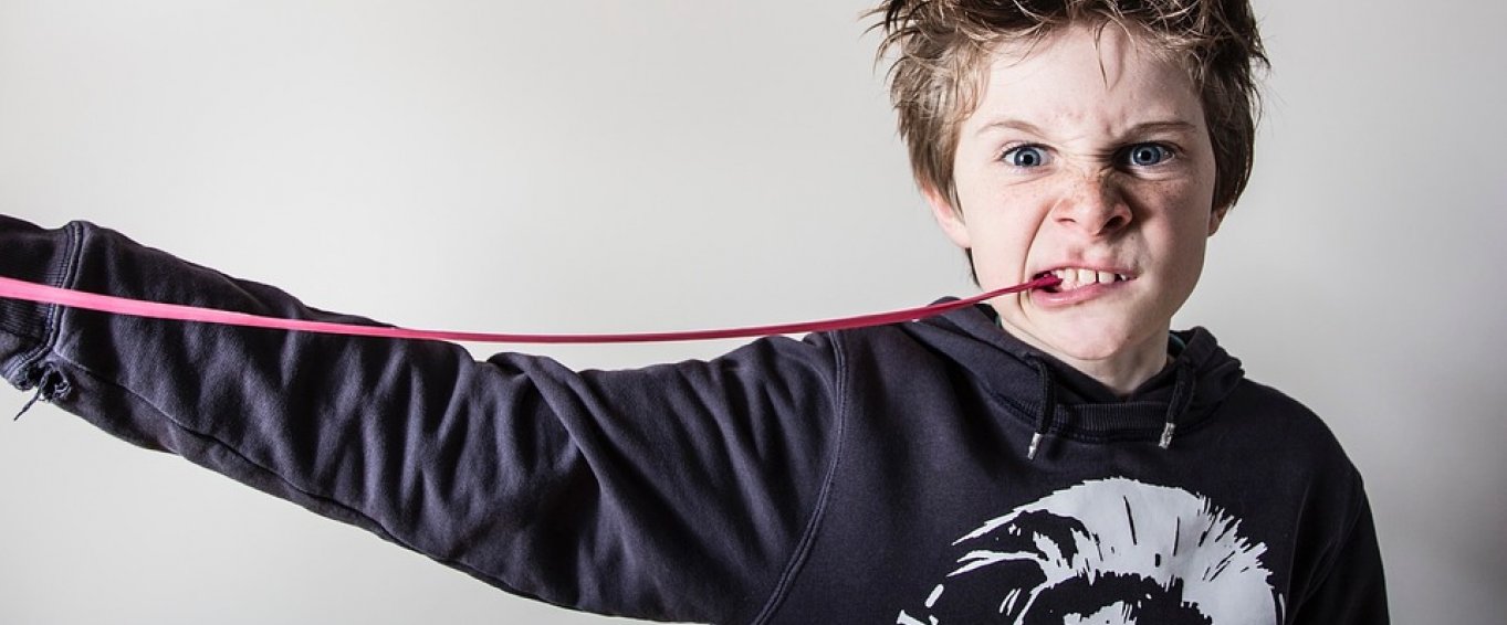 Young Boy Chewing Gum and Pulling a Fierce Face