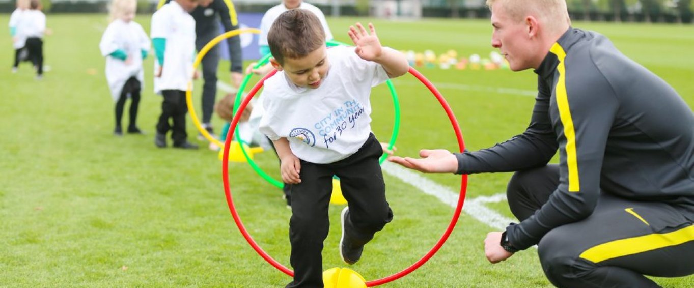 Children Jumping Through Coloured Hula Hoops