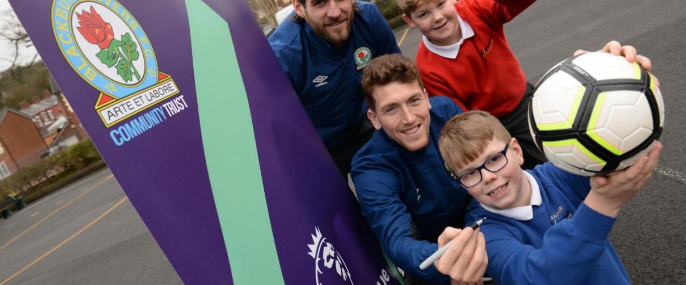 Two Blackburn Rovers Football Players Posing with Three Schoolkids 