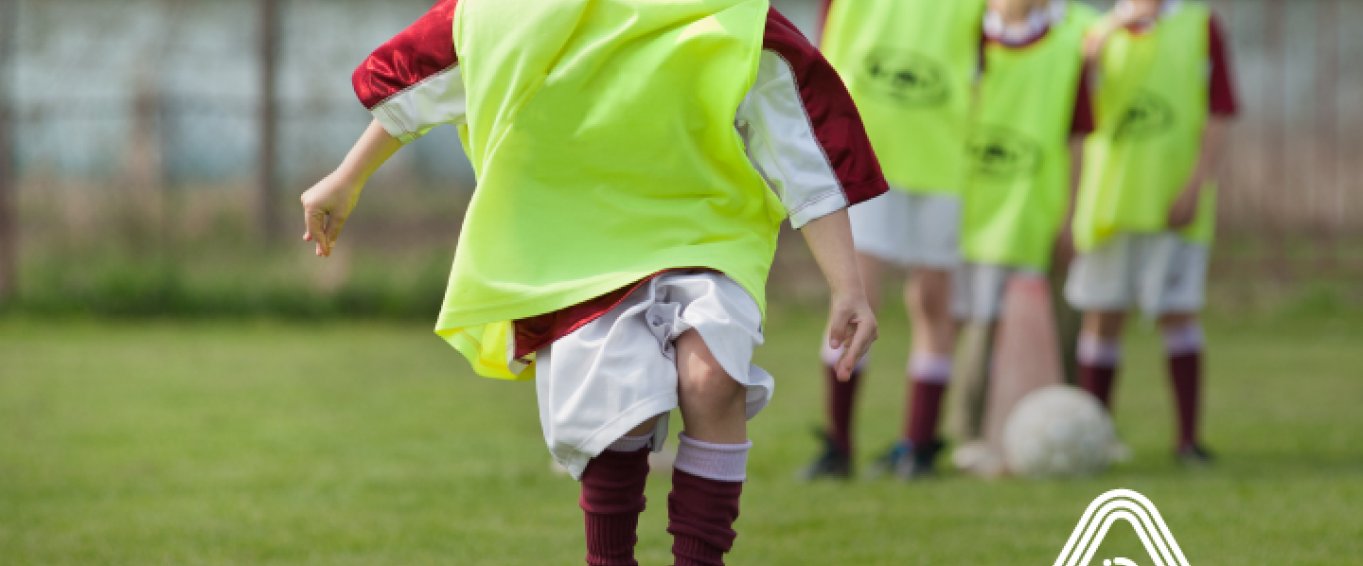 Young boy playing football Amaven