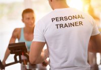 Personal Trainer training client on an exercise bike